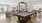 a room with a pool table and chairs
