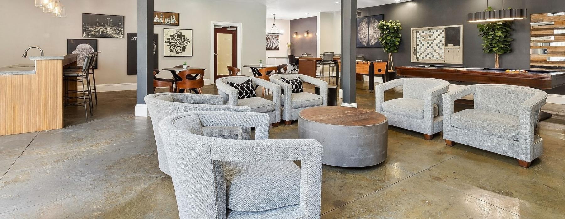 a large room with white couches and tables