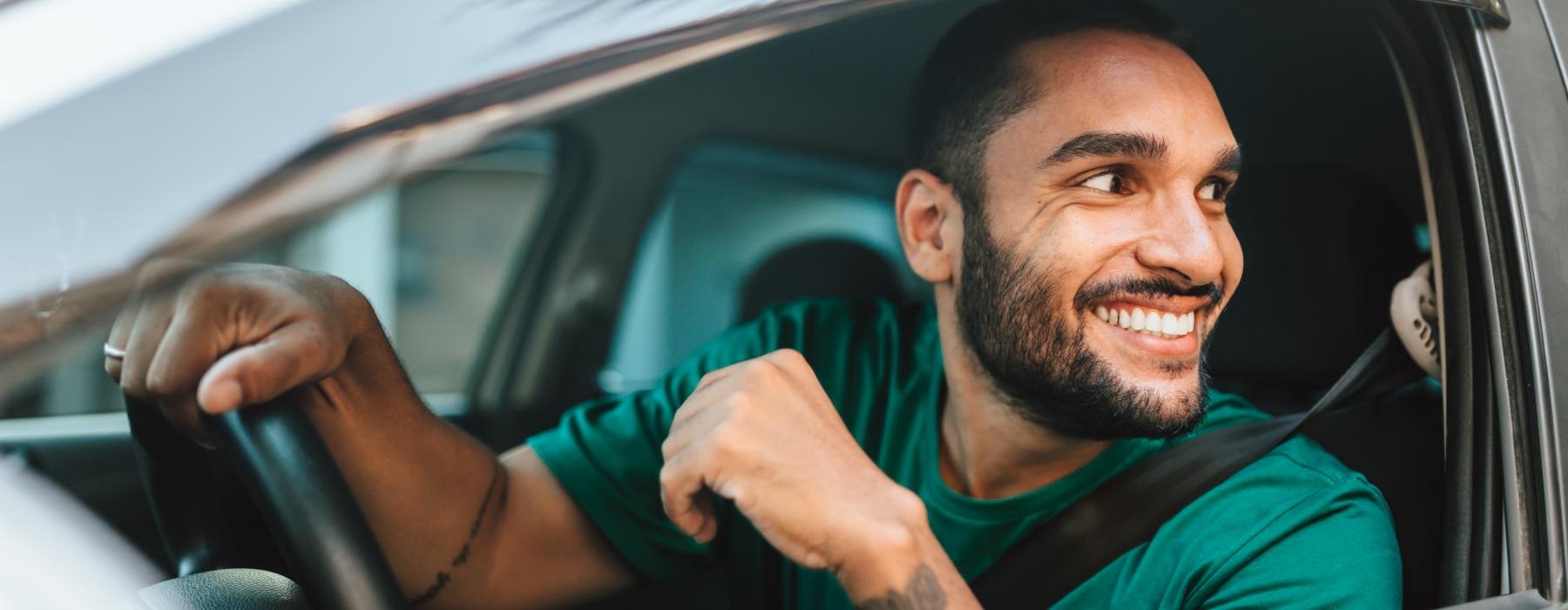 a person smiling and sitting in a car