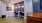 a room with a desk and chairs