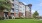 a large building with a lawn in front of it